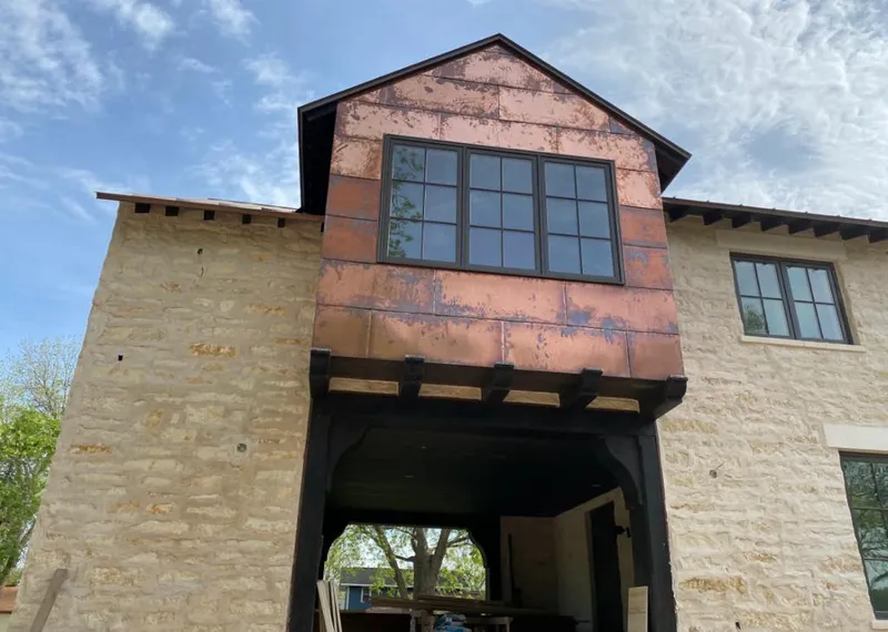 Copper metal panel facade on a stone building for Roof Repair in River Edge